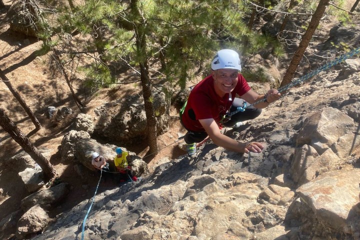 a group of people climbing a rocky mountain