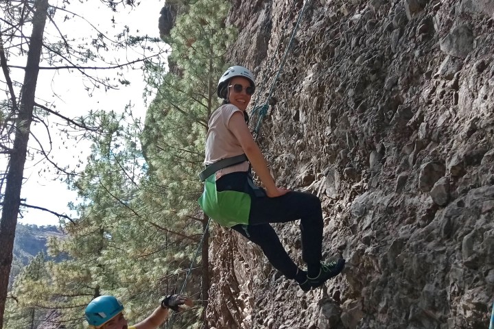 a group of people climbing a rocky mountain
