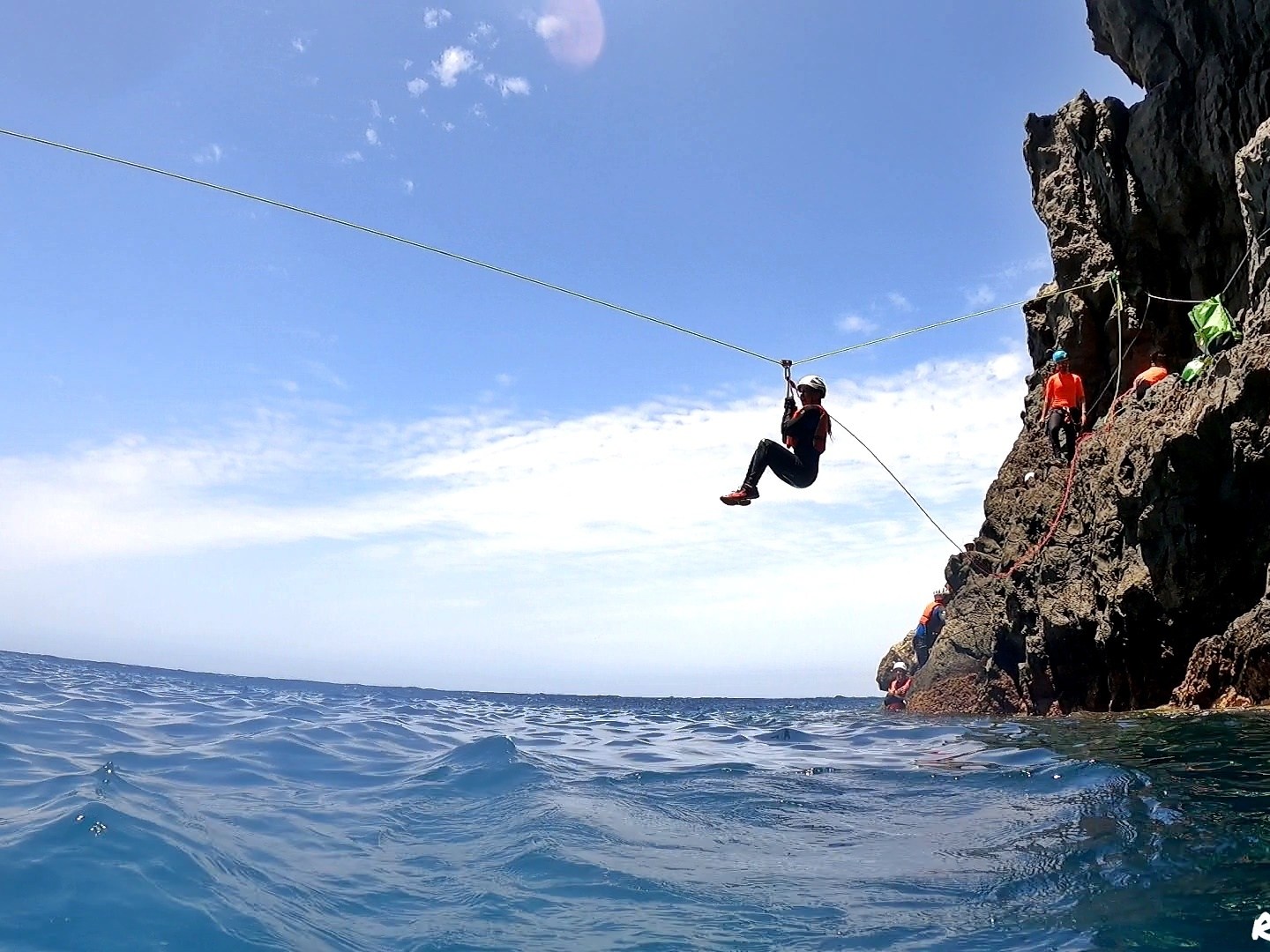 a person ziplining from rocky cliffs