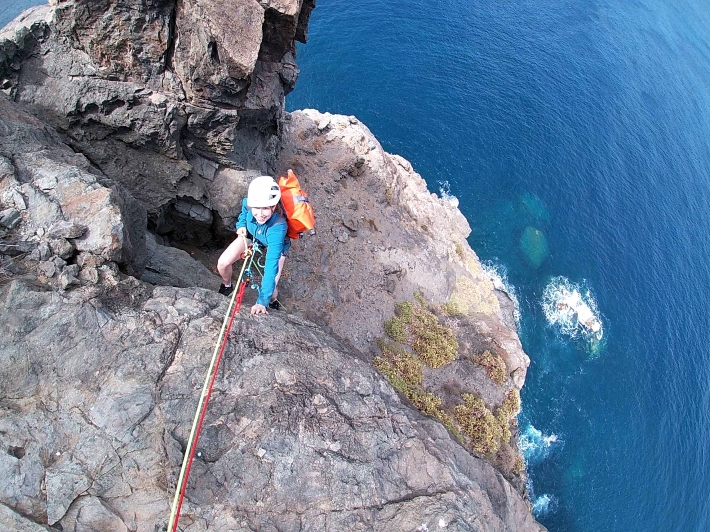 a person climbing a rocky cliff