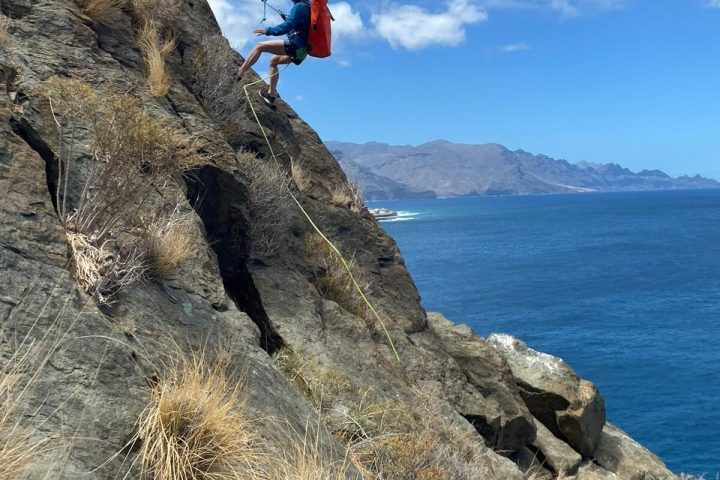 a person climbing a rocky cliff