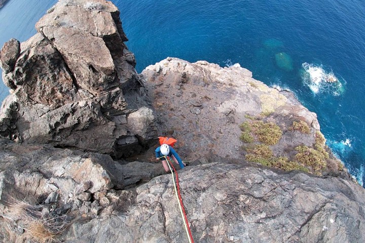 a person climbing a rocky cliff