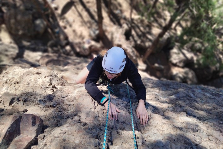 a man riding on top of a rock
