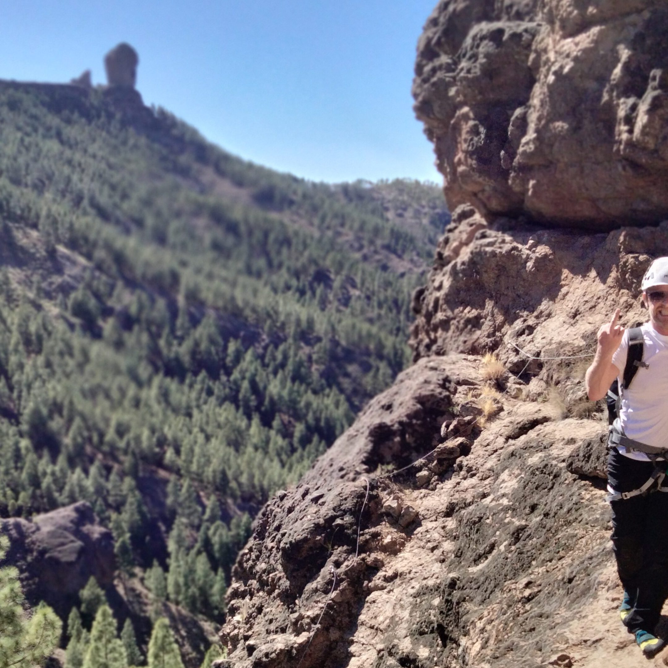 a man standing on a rocky hill