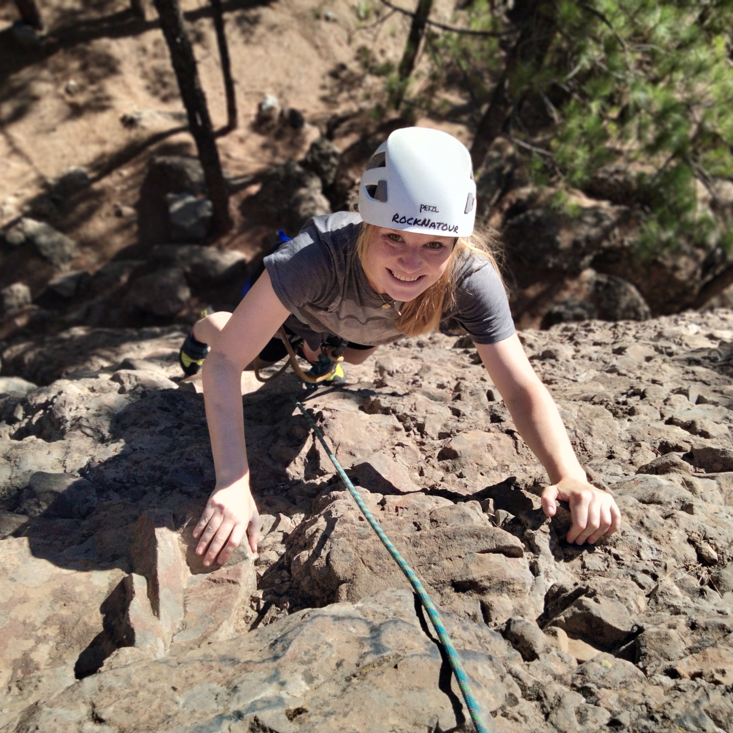 a young boy standing on a rock