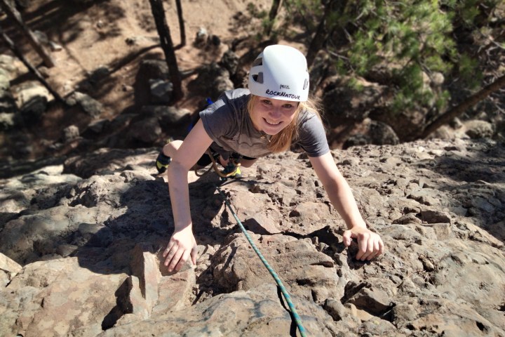 a young boy standing on a rock
