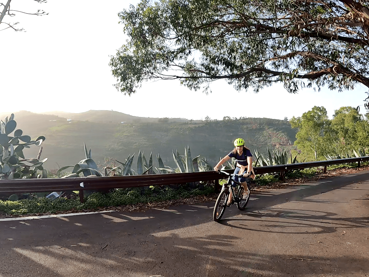 a person riding a bike down a dirt road