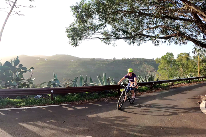 a person riding a bike down a dirt road