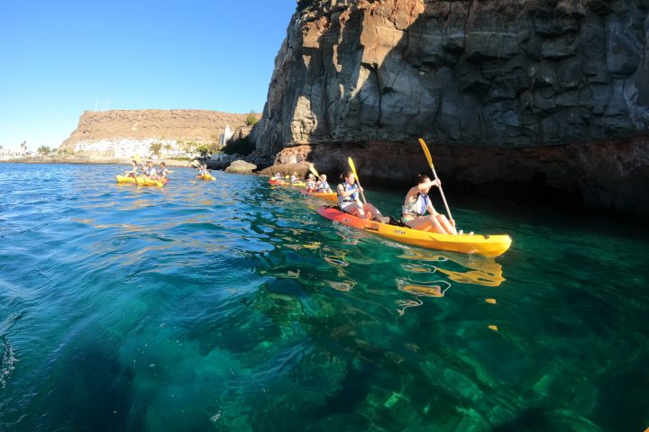 a person sitting on a rock near the ocean