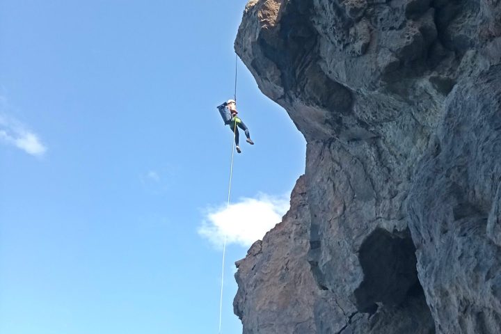 a person standing in front of a rocky mountain