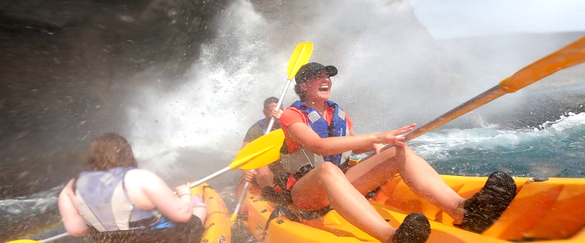kayaking puerto mogan caves snorkel gran canaria a person in a raft on the water