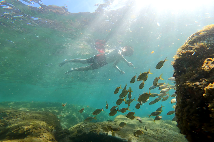 a man that is standing in the water