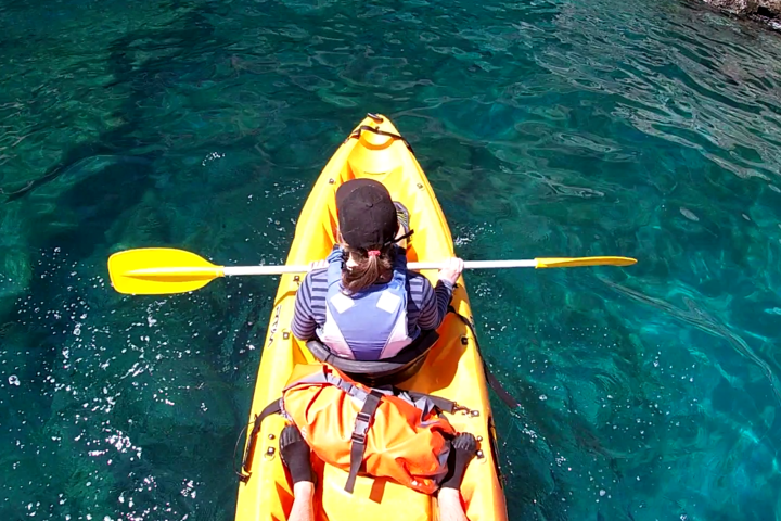 a person standing next to a body of water