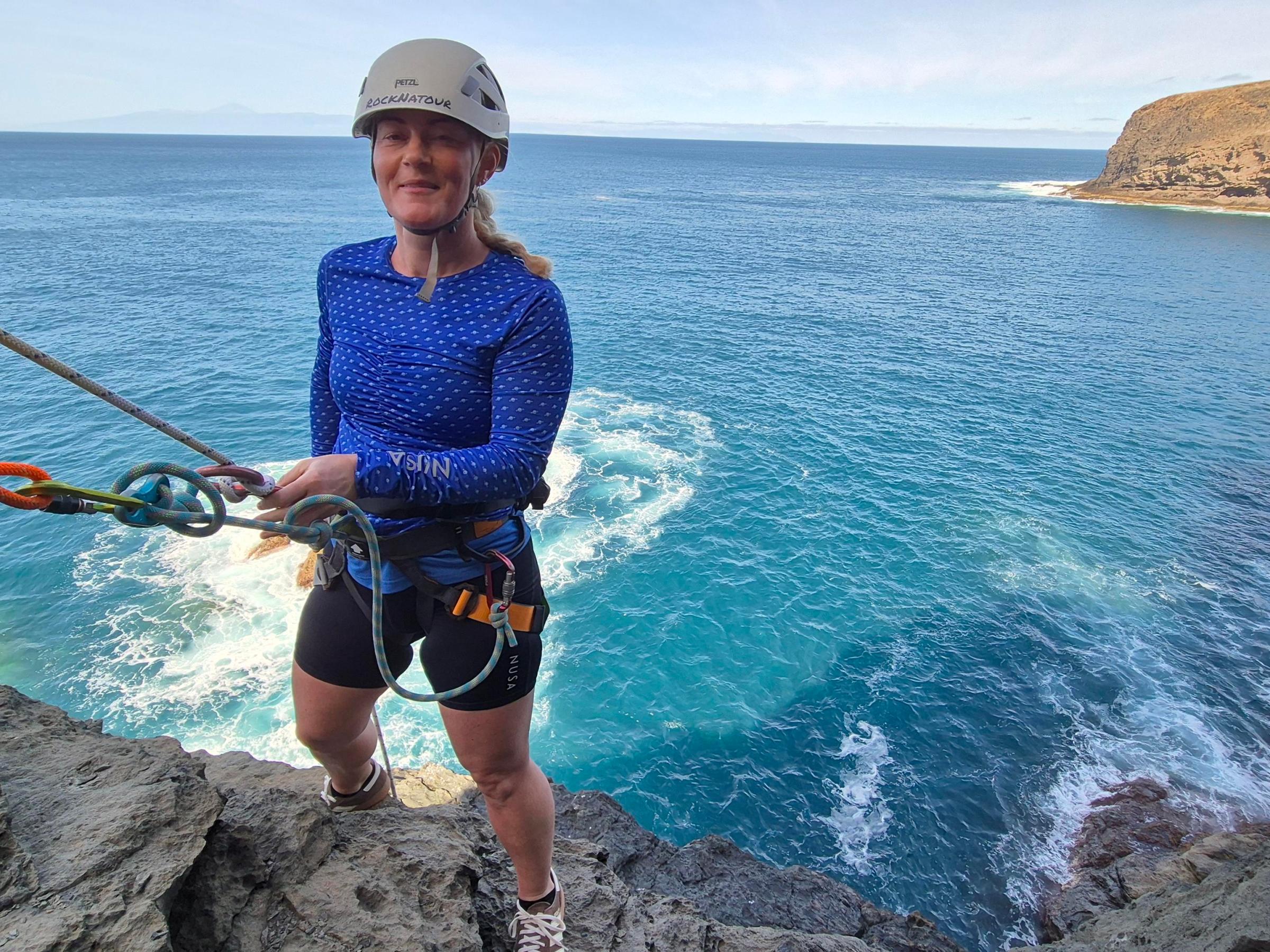 a person standing next to a body of water