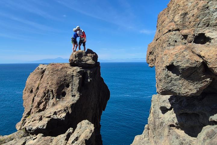 a man doing a trick on a rocky hill