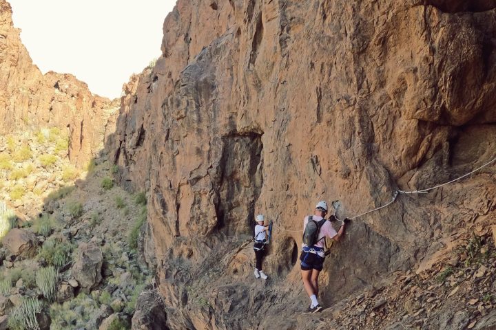 a man standing on a rocky hill