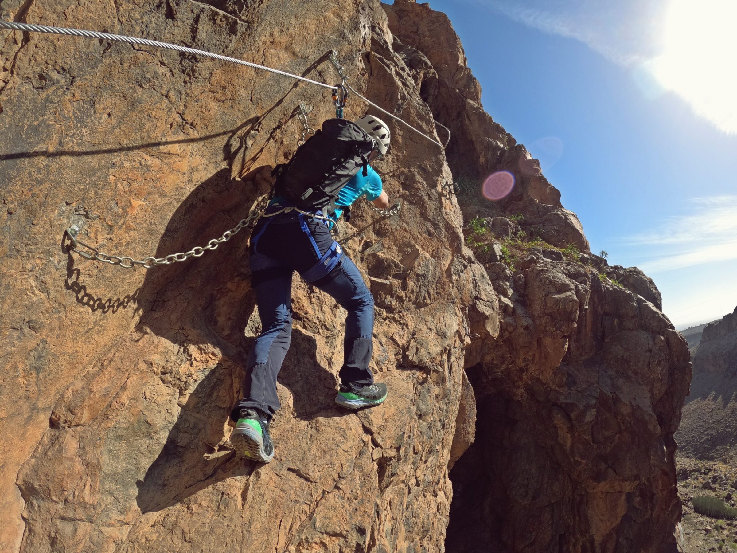 a man flying through the air on a rocky hill