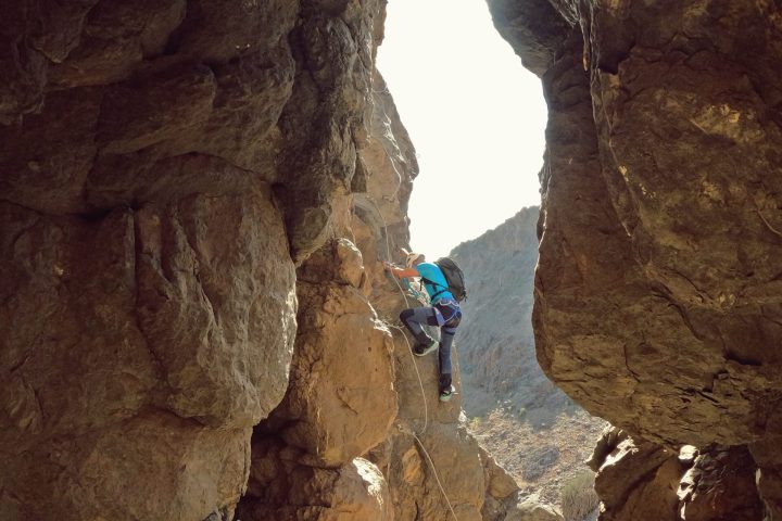 a man riding on the back of a cave