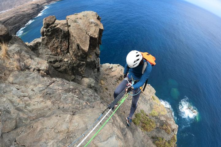 a man riding a skateboard up the side of a mountain