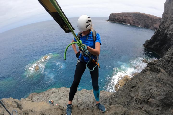 a man riding a board on a body of water